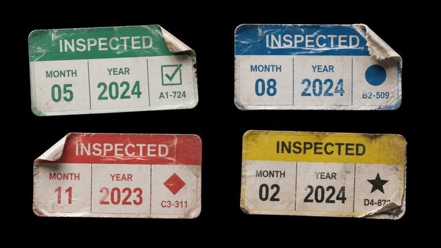 Worn inspection stickers with different colors on black background