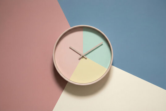 Pastel clock on geometric color block background with mint, pink, yellow and blue quadrants for minimal design, poster, social media and interior decor layout