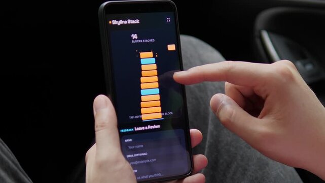 User plays a mobile block stacking game, building a taller tower with each tap and testing timing, balance and concentration through fast casual gameplay.