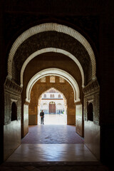 Naklejka premium Sunlight and shadows in passageway to courtyard in Alhambra