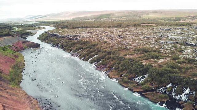 Iceland Waterfalls aerial view. Hraunfossar on a cloudy summer day. Slow motion