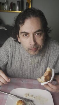 Close Up Shot of Man Eating Fried papa rellena at Table