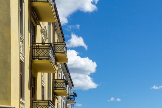 Oslo building facade with balconies against blue sky