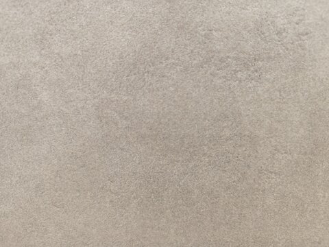 Close up of light greige microcement wall texture with smooth concrete background
