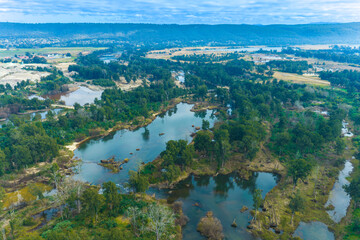 Fototapeta premium Drone aerial photograph of the Nepean River surrounded by lush bushland as it flows towards the Penrith Lakes region in the Greater Western Sydney town of Penrith in New South Wales, Australia