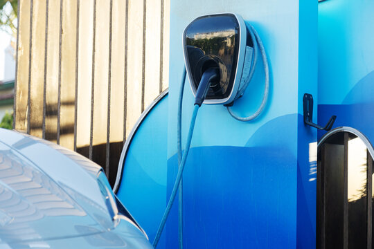 Electric vehicle charging at a modern blue station