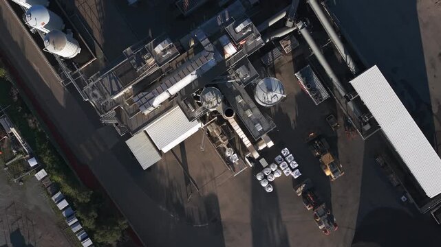 High angle zenithal shot of a concrete production plant and its industrial vehicles in operation