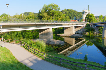 Fototapeta premium Concrete bridge spanning river with reflections in Schongau Germany