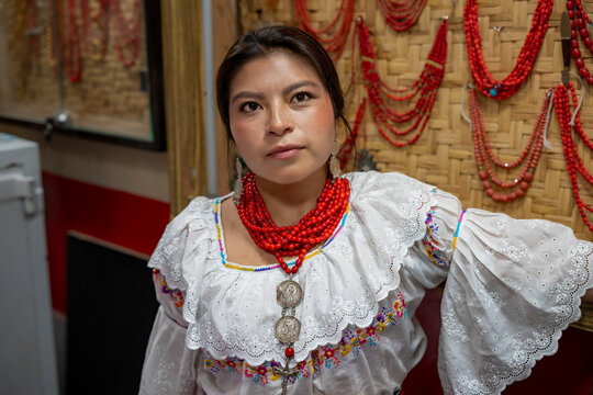 Woman in traditional dress with red bead necklace