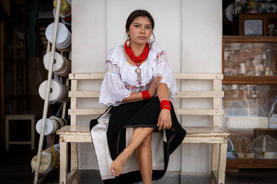 Woman in traditional dress with red bead necklace