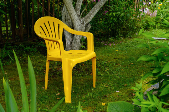 Bright Yellow Garden Chair in a Green Summer Garden