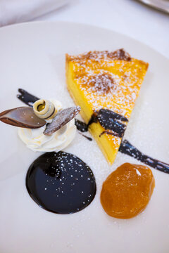 Piece of italian cheesecake served with whipped cream and chocolate