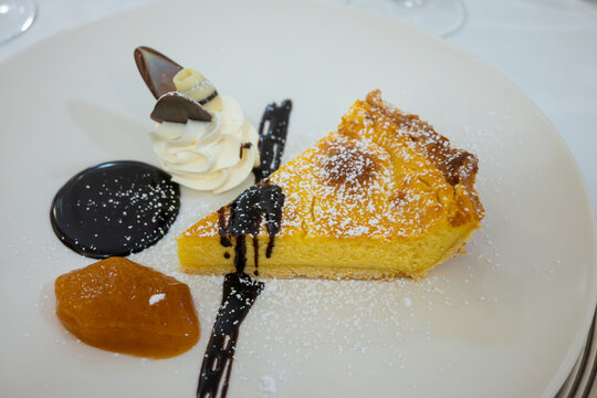 Piece of italian cheesecake served with whipped cream and chocolate