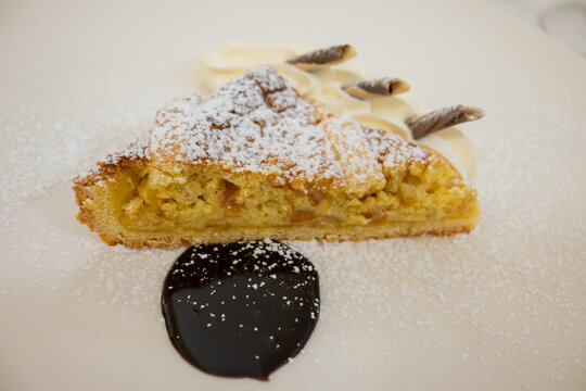 Piece of italian cheesecake served with whipped cream and chocolate
