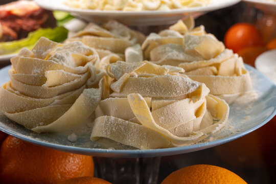 Fresh make artisalan pasta uncooked on plate by entrance in traditional osteria trattoria restaurant in Rome, Italy, Italian food