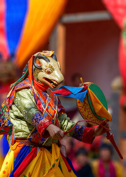 Bhutan, In the village of Bumthang, monks in colorful costumes dance during the annual Jakar festival.
