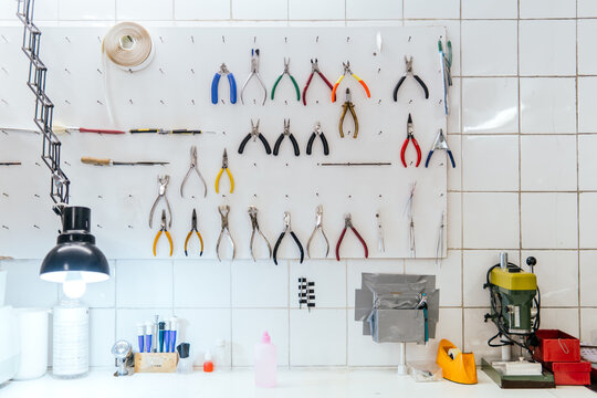 Optical workshop tool wall with pliers and drill press