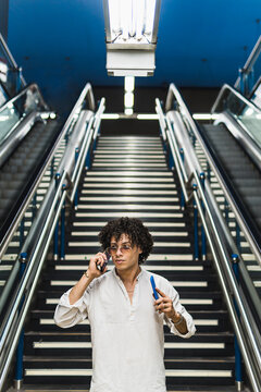 Man use smartphone on subway station escalator stairs