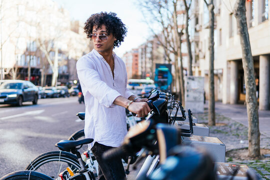 Man with bicycle on urban street