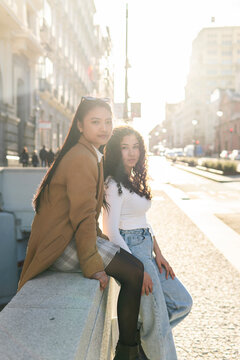 Friends enjoy urban sunshine on a Madrid street