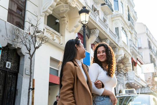 Friends enjoy an urban walk through Madrid streets