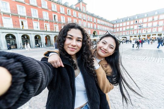 Friends take selfie in Madrid's Plaza Mayor square