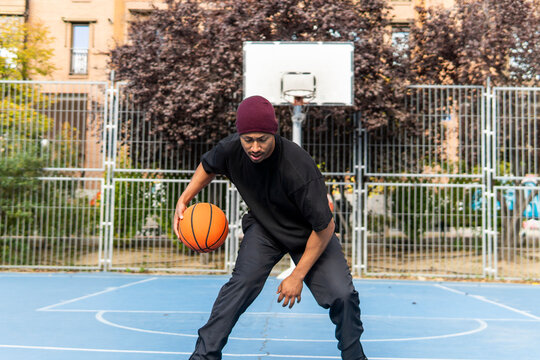 Man dribble basketball on outdoor court