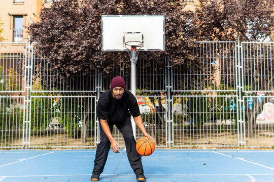 Man play basketball on outdoor court with ball