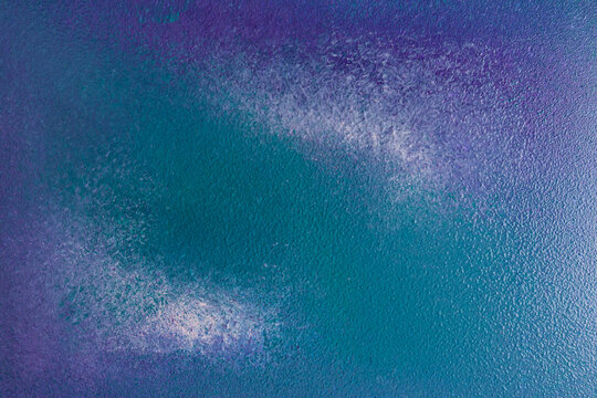 Abstract teal and purple textured background with soft shimmer