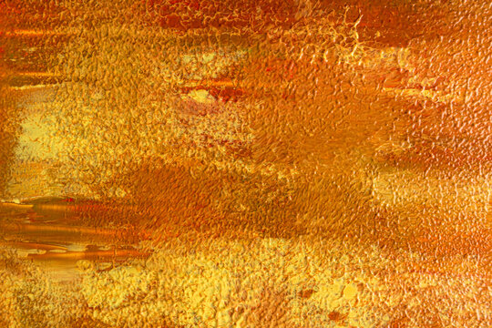 Bright autumn abstract texture with golden orange paint