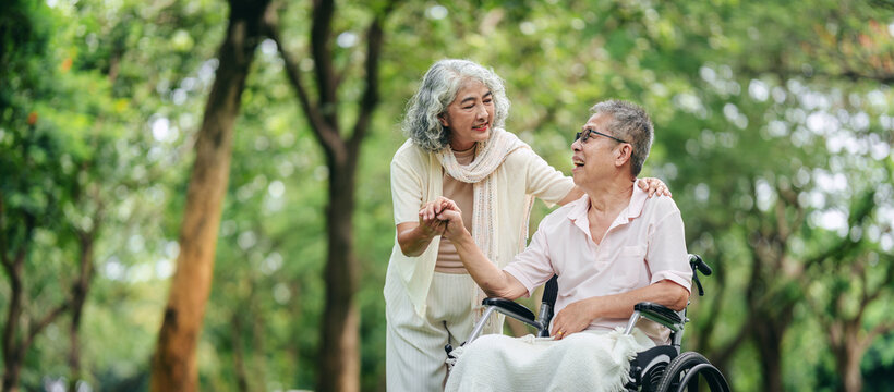 Senior couple sharing love support outdoors in park woman assist