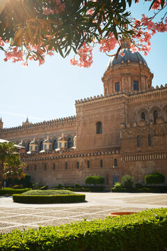 Palermo Cathedral framed by pink blossoms in Sicily, Italy