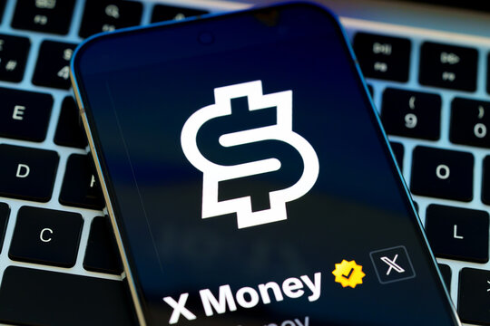 X Money logo and verified account displayed on a smartphone resting on a laptop keyboard in a digital payments concept. Stafford, United Kingdom, August 2, 2026.
