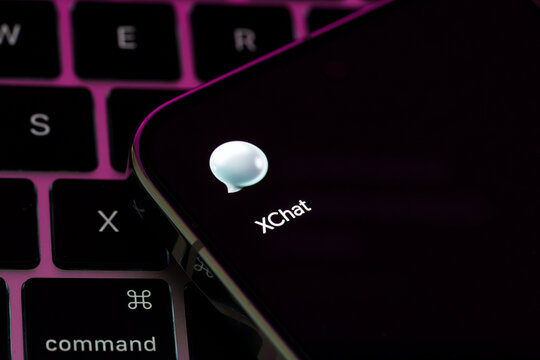 XChat app icon displayed on a smartphone resting on a laptop keyboard in a mobile messaging illustration. Stafford, United Kingdom, August 2, 2026.