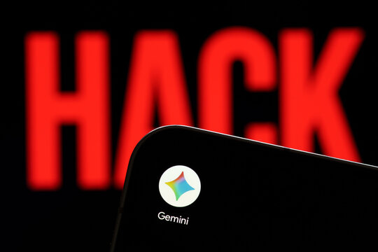 Google Gemini app logo shown on a smartphone against a red HACK warning in an artificial intelligence cybersecurity concept. Stafford, United Kingdom, August 2, 2026.