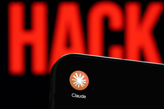 Claude app logo shown on a smartphone against a red HACK warning in an artificial intelligence cybersecurity concept. Stafford, United Kingdom, August 2, 2026.