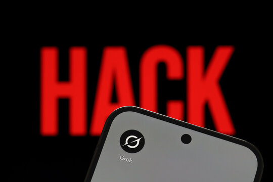Grok app logo shown on a smartphone against a red HACK warning in an artificial intelligence cybersecurity concept. Stafford, United Kingdom, August 2, 2026.