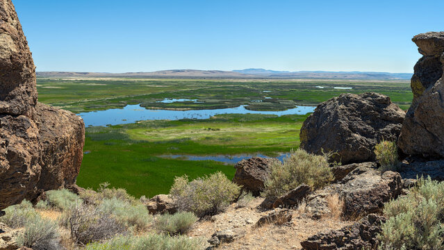 Panorama of the ponds in the marsh framed by boulders on the Buena Vista Overlook in Oregon, USA