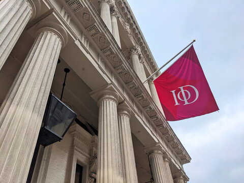 Institute of Directors headquarters at 116 Pall Mall with fluted columns and IoD flag in London