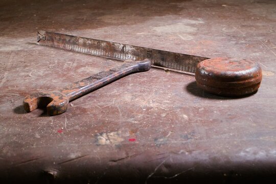 close-up of an old rusty wrench and measuring tape