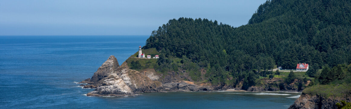 Scenic view of Heceta Head Lighthouse, headland, and pacific ocean, summer road trip to explore Oregon State Parks on the coast
