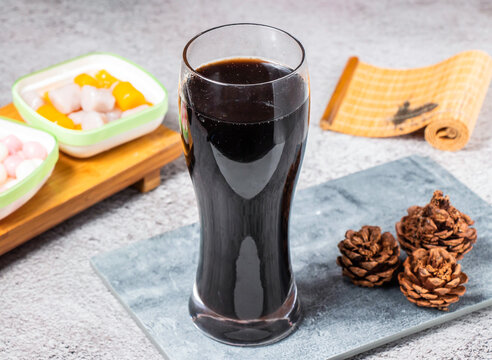 Glass of refreshing herbal grass jelly tea. Traditional Asian sweet dessert drink beverage.