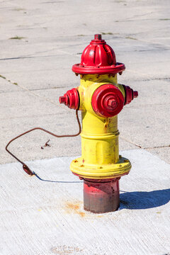 old  fire hydrant or firecock with red painted head at the beach promenade