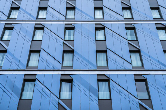 Modern blue building facade with geometric window pattern