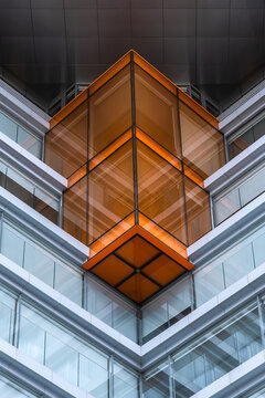 Modern glass building facade with orange corner detail
