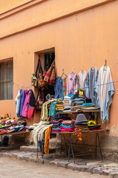 Street market textiles on Purmamarca adobe wall, Argentina