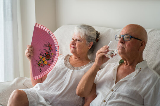 Senior couple cope with extreme heat indoors at home