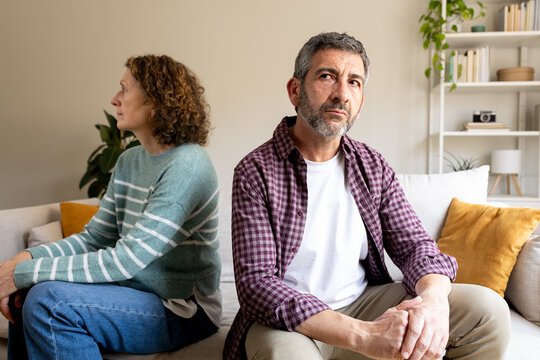 Mature couple having relationship problems on sofa at home