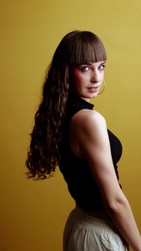 Energetic young woman dancing with flowing hair