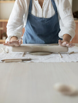 Potter artist forming clay in a focused and creative ceramic studio